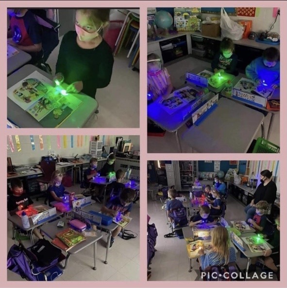students reading with flashlights