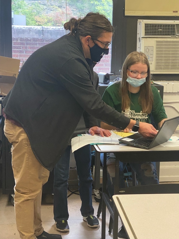teacher helping a student